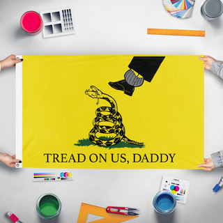A mockup of the custom flag 'TREAD ON US, DADDY SM flag' held up on a table during print checking