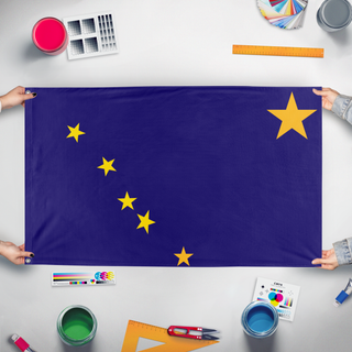 A mockup of the custom flag 'Alaska  flag' held up on a table during print checking
