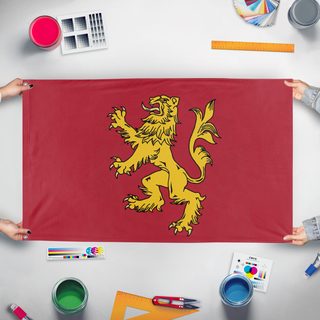 A mockup of the custom flag 'House Lannister  flag' held up on a table during print checking