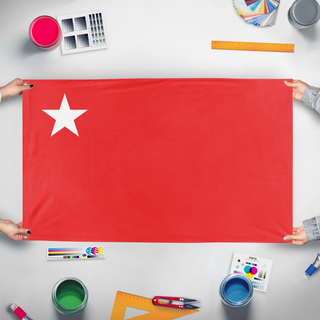 A mockup of the custom flag 'Myamar People's Defence Force  flag' held up on a table during print checking