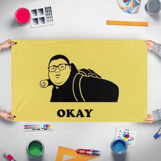 A mockup of the custom flag 'okay flag' held up on a table during print checking