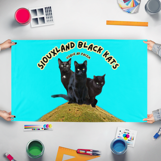 A mockup of the custom flag 'Siouxland Black Kats flag' held up on a table during print checking