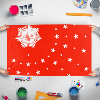 A mockup of the custom flag 'xijang clique flag' held up on a table during print checking