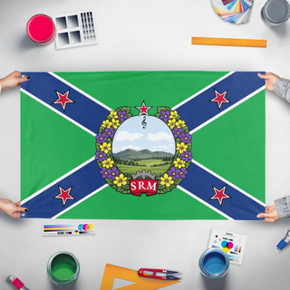 A mockup of the custom flag 'Student Resistance Militia flag' held up on a table during print checking