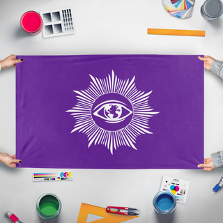 A mockup of the custom flag 'The Eye in the Light flag' held up on a table during print checking