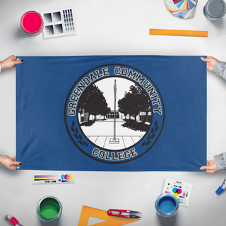 A mockup of the custom flag 'Greendale Community College flag' held up on a table during print checking
