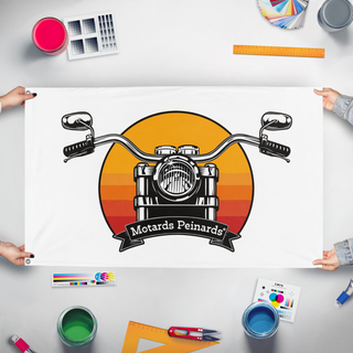 A mockup of the custom flag 'Drapeau Motards Peinards flag' held up on a table during print checking