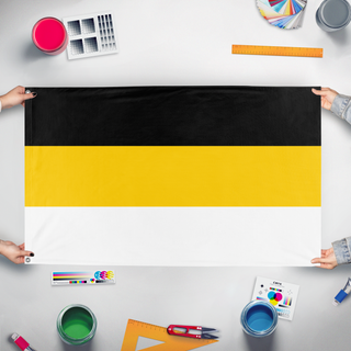 A mockup of the custom flag 'Russian Empire 1858 flag' held up on a table during print checking