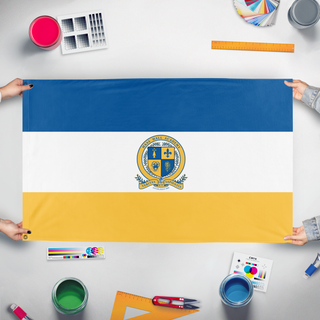 A mockup of the custom flag 'Haas Hall Flag 2' held up on a table during print checking