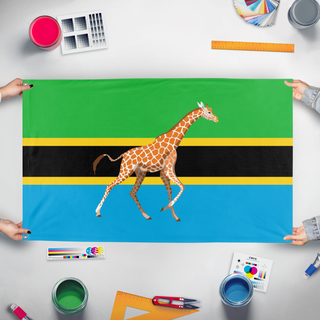 A mockup of the custom flag 'Tanzania In the Style of Wales flag' held up on a table during print checking