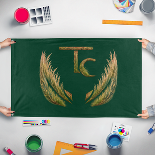 A mockup of the custom flag 'TC Prairie Grasses flag' held up on a table during print checking