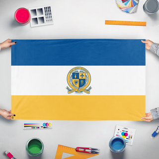 A mockup of the custom flag 'Graduation Hand Flag, Haas Hall' held up on a table during print checking