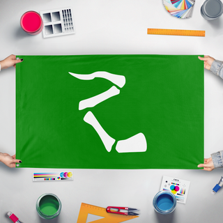 A mockup of the custom flag 'Hoof and Horn Flag 1999' held up on a table during print checking