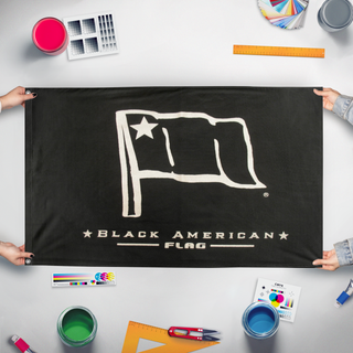 A mockup of the custom flag 'BLM flag' held up on a table during print checking