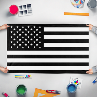 A mockup of the custom flag 'Black United States flag' held up on a table during print checking