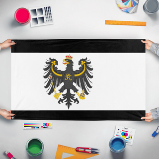A mockup of the custom flag 'Prussia Flag Redesign' held up on a table during print checking