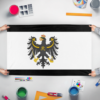 A mockup of the custom flag 'Prussia Flag Redesign 2' held up on a table during print checking