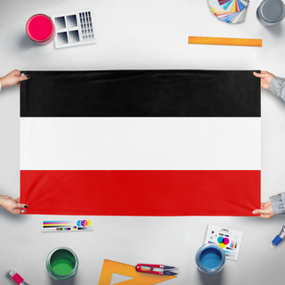 A mockup of the custom flag 'German Empire flag' held up on a table during print checking