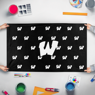 A mockup of the custom flag 'Warrior W's Black/white flag' held up on a table during print checking