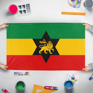 A mockup of the custom flag 'Rasta Carribean Empire flag' held up on a table during print checking