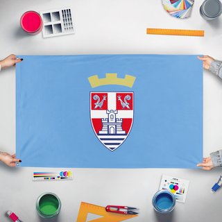 A mockup of the custom flag 'Trebinje flag' held up on a table during print checking