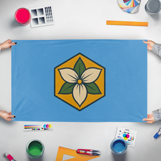 A mockup of the custom flag 'Trillium flag' held up on a table during print checking