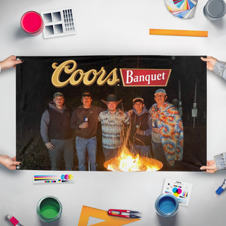 A mockup of the custom flag 'Coors Banquet flag' held up on a table during print checking