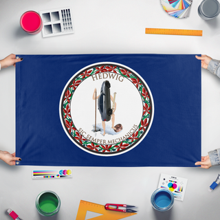 A mockup of the custom flag 'Hedwig flag' held up on a table during print checking