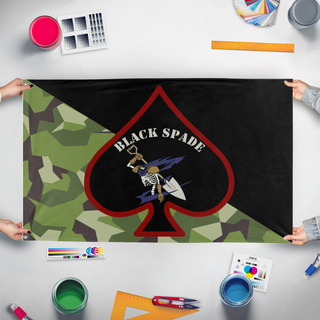 A mockup of the custom flag 'Black Spade flag' held up on a table during print checking