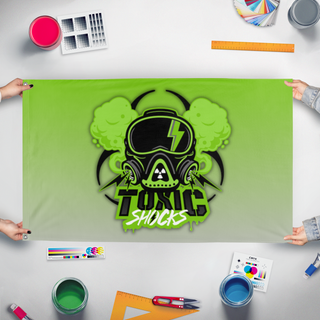 A mockup of the custom flag 'Toxic Shocks flag' held up on a table during print checking