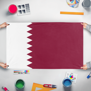 A mockup of the custom flag 'QATAR flag' held up on a table during print checking