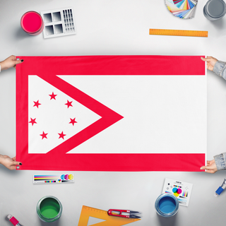 A mockup of the custom flag 'absaroka state flag redesign' held up on a table during print checking