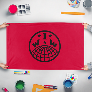 A mockup of the custom flag 'IWW flag' held up on a table during print checking