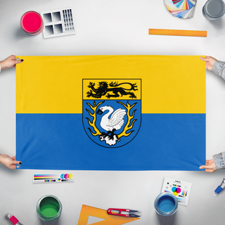 A mockup of the custom flag 'Flag of Aachen' held up on a table during print checking