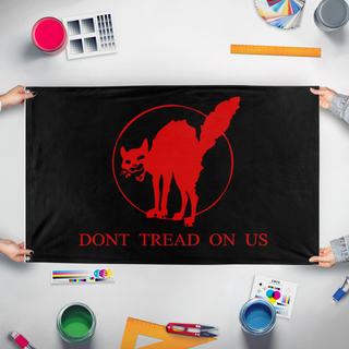 A mockup of the custom flag 'Sabot Gadsen flag' held up on a table during print checking