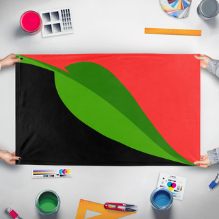 A mockup of the custom flag 'Libertarian Municipalism flag' held up on a table during print checking