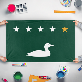 A mockup of the custom flag 'Loon flag' held up on a table during print checking