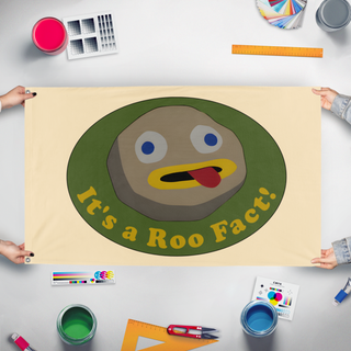 A mockup of the custom flag 'roo fact! flag' held up on a table during print checking