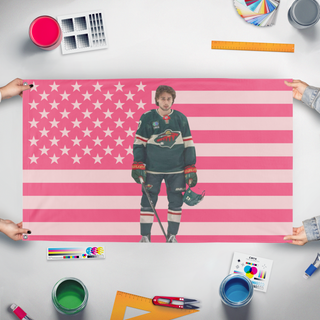 A mockup of the custom flag 'QuinnHuges flag' held up on a table during print checking