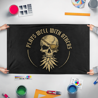 A mockup of the custom flag 'Jolliest of Rodgers flag' held up on a table during print checking