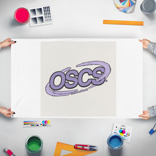 A mockup of the custom flag 'OSCS flag' held up on a table during print checking