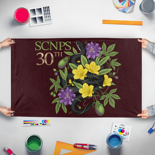 A mockup of the custom flag 'SCNPS flag' held up on a table during print checking