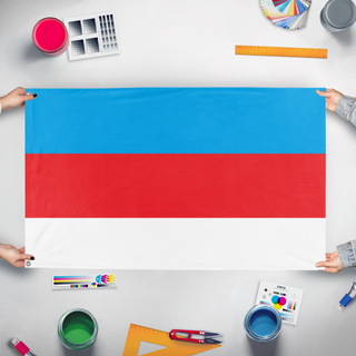 A mockup of the custom flag 'Flag of Vancia' held up on a table during print checking