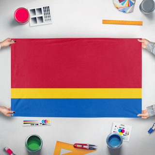 A mockup of the custom flag 'Koslan flag' held up on a table during print checking