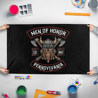 A mockup of the custom flag 'Men of Honor Motorcycle Club flag' held up on a table during print checking