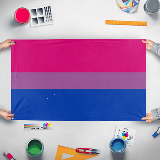 A mockup of the custom flag 'bi flag' held up on a table during print checking