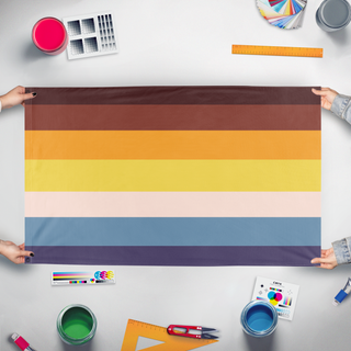 A mockup of the custom flag 'BLACK AROACE flag' held up on a table during print checking
