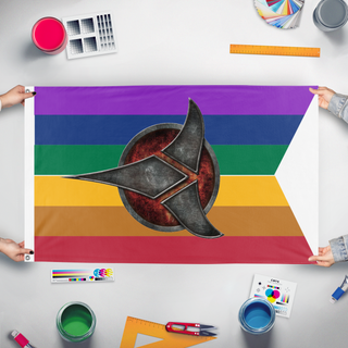 A mockup of the custom flag 'LGBT-ST-Klingon flag' held up on a table during print checking