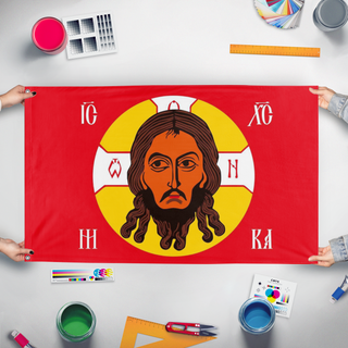 A mockup of the custom flag 'Holy face of Christ flag' held up on a table during print checking