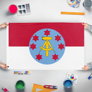 A mockup of the custom flag 'Spatland flag' held up on a table during print checking